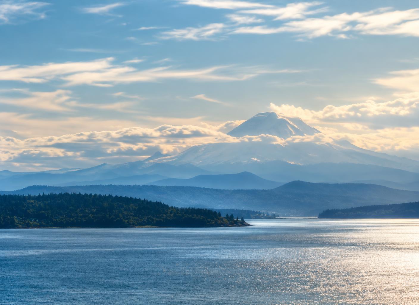 Mount Rainier above Puget Sound under a bright sky
